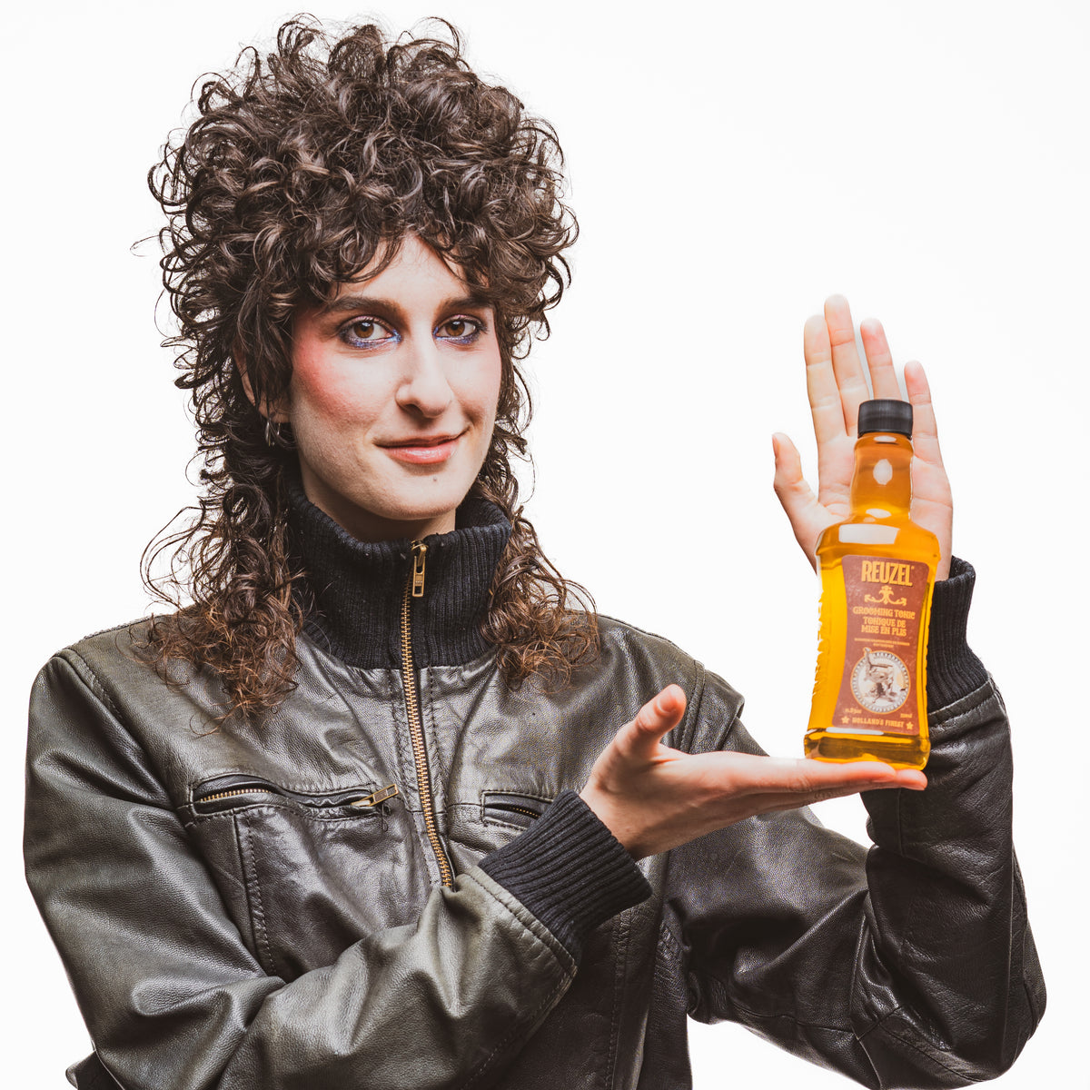 Reuzel grooming tonic bottle for hair styling, featuring a clear liquid inside a sleek bottle with minimal branding.
