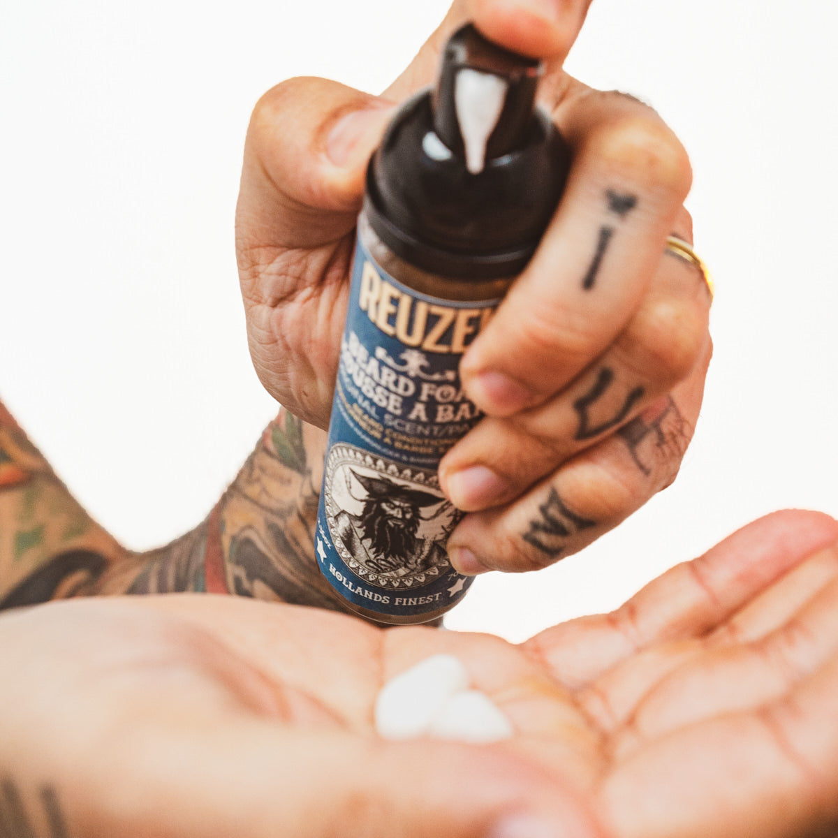 Reuzel Wood & Spice Beard Foam in a bottle, part of a beard care gift set with beard balm and grooming products.