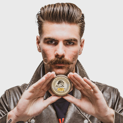 Reuzel The Stache Mustache Wax in a tin, featuring a natural mustache wax with a smooth texture and branding on the lid.
