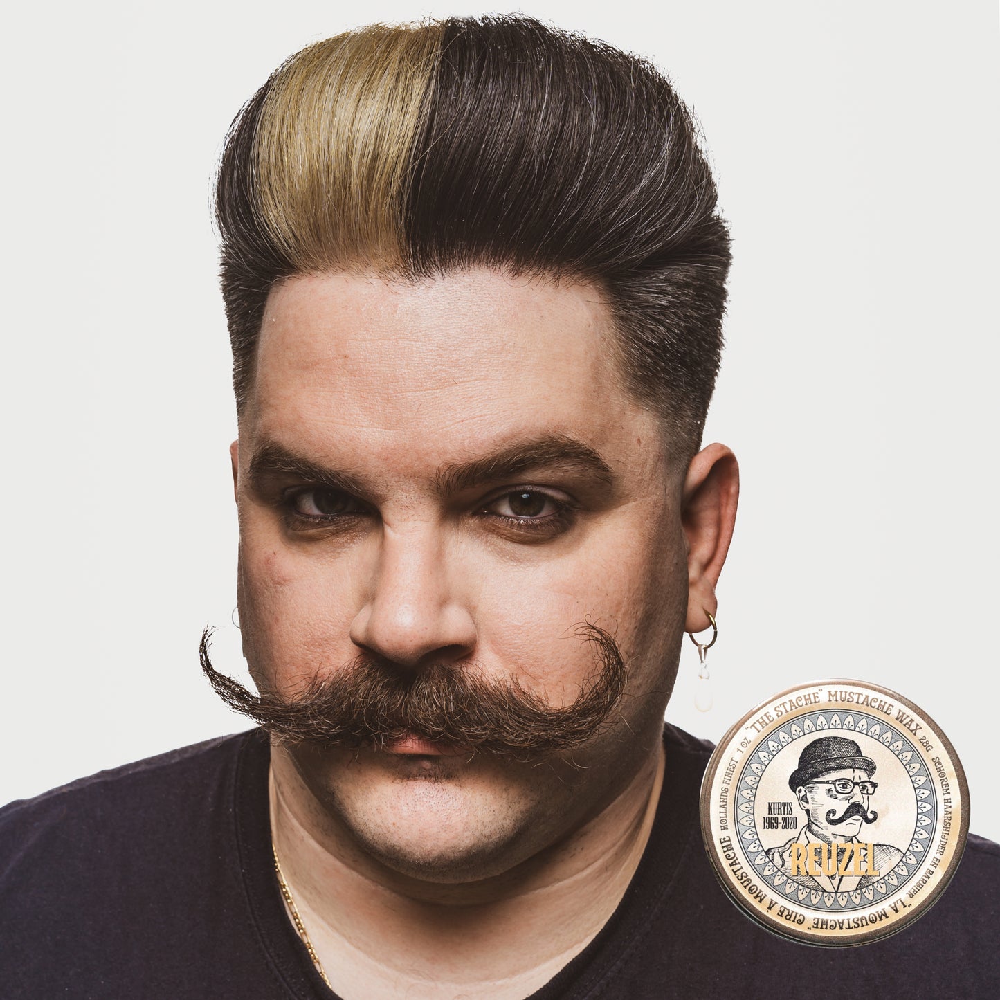 Reuzel The Stache Mustache Wax in a small jar, designed for shaping and styling mustaches and facial hair.